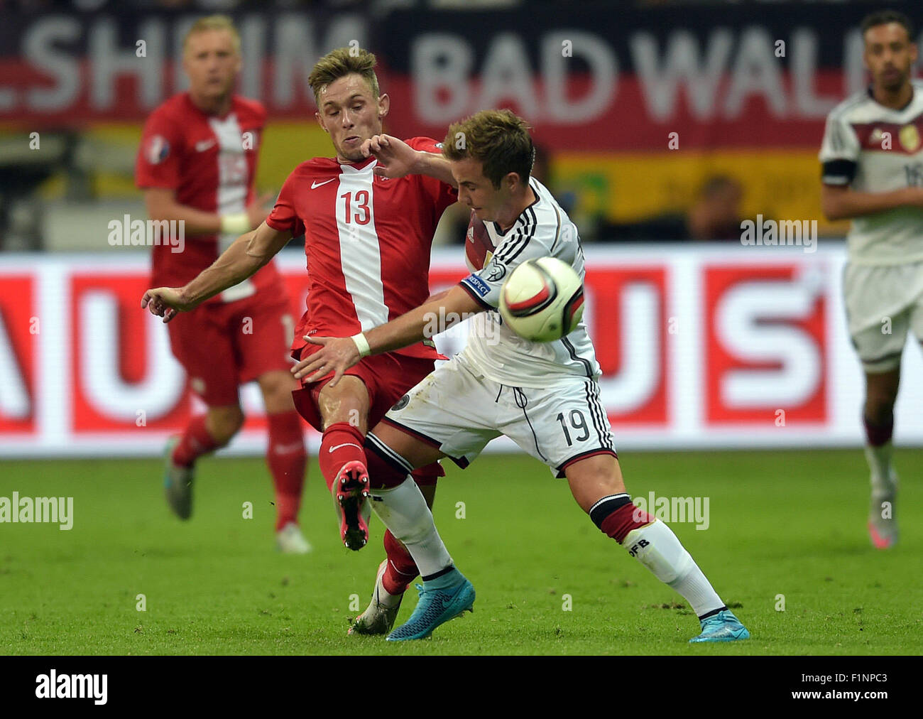 Germany's Mario Goetze (r) and Poland's Maciej Rybus compete for the ball during the Group D qualifier for the European Championships at the Commerzbank-Arena in Frankfurt am Main, Germany, 4 September 2015. PHOTO: FEDERICO GAMBARINI/DPA Stock Photo