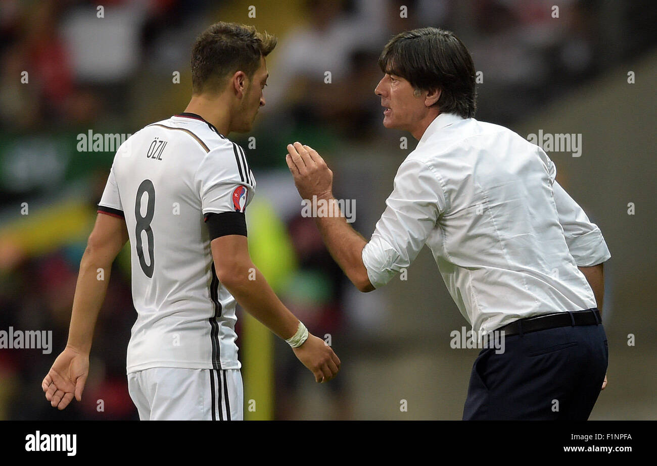 Germany head coach Joachim Loew (R) speaks to Mesut Oezil during the Group D qualifier for the European Championships at the Commerzbank-Arena in Frankfurt am Main, Germany, 4 September 2015. PHOTO: FEDERICO GAMBARINI/DPA Stock Photo