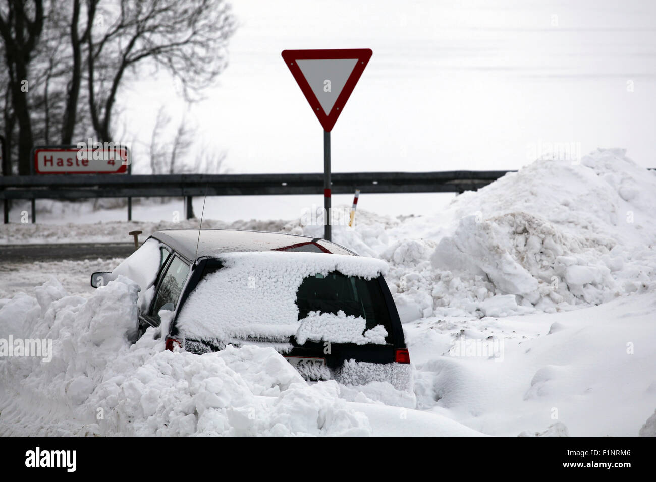 Snowbank at road stops car. Stock Photo