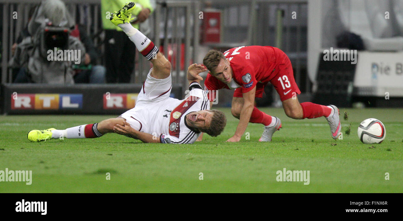 Germany's Thomas Mueller (l) and Poland's Maciej Rybus compete for the ball during the Group D qualifier for the European Championships at the Commerzbank-Arena in Frankfurt am Main, Germany, 4 September 2015. PHOTO: FREDRIK VON ERICHSEN/DPA Stock Photo
