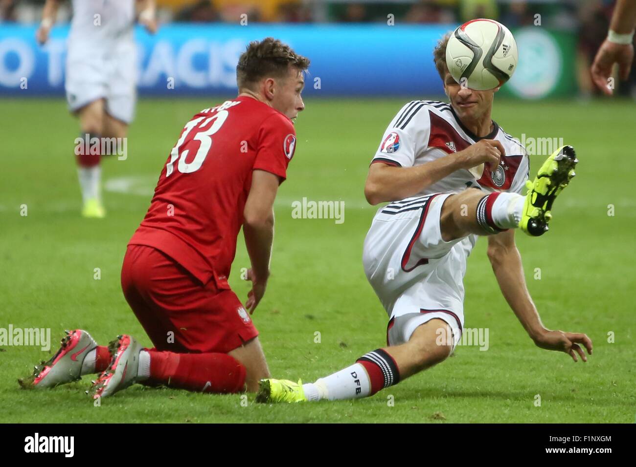 Germany's Thomas Mueller (vorn) and Poland's Maciej Rybus compete for the ball during the Group D qualifier for the European Championships at the Commerzbank-Arena in Frankfurt am Main, Germany, 4 September 2015. PHOTO: FREDRIK VON ERICHSEN/DPA Stock Photo
