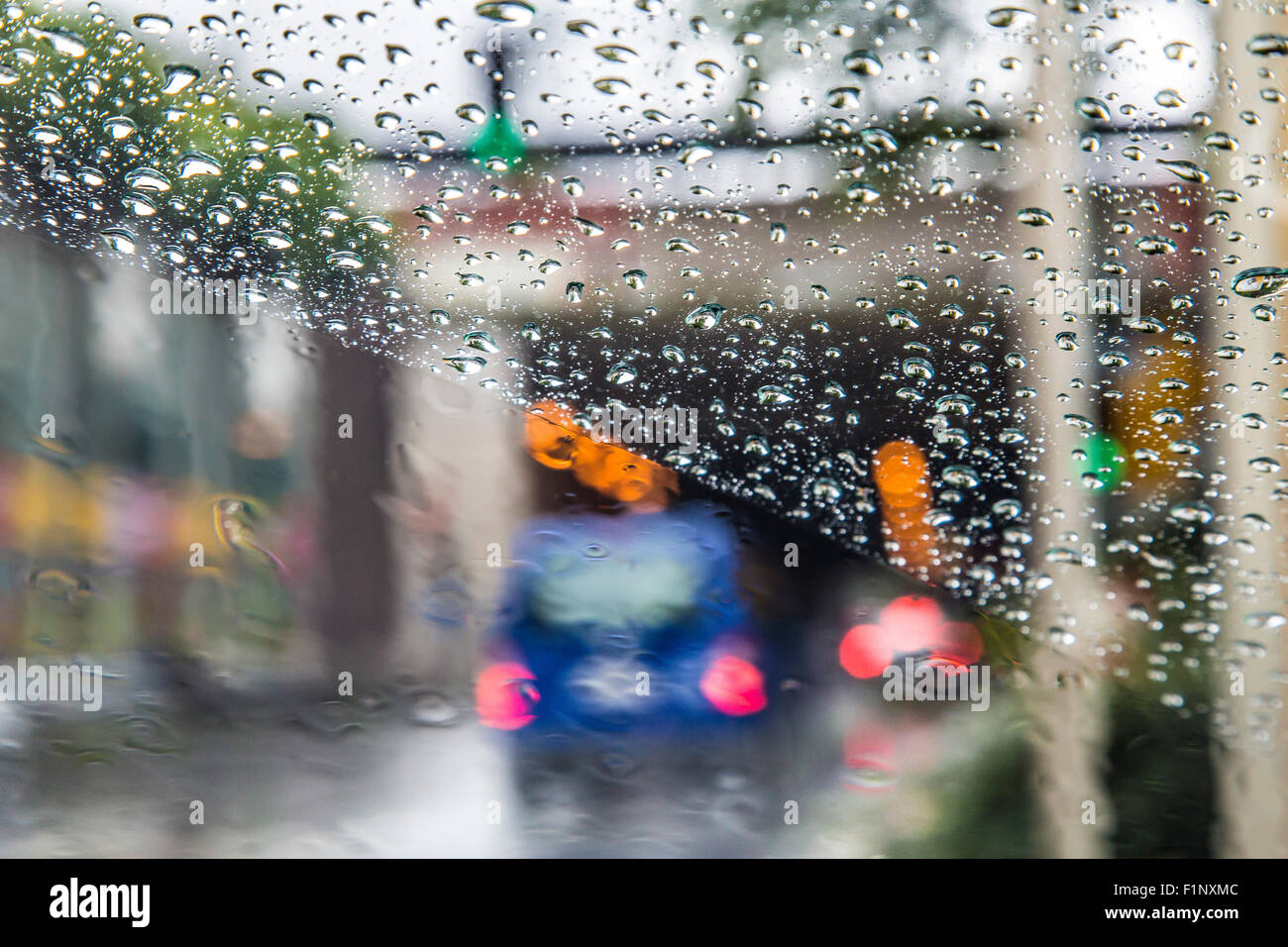 Cars driving in heavy rain weather, wet surface of the street