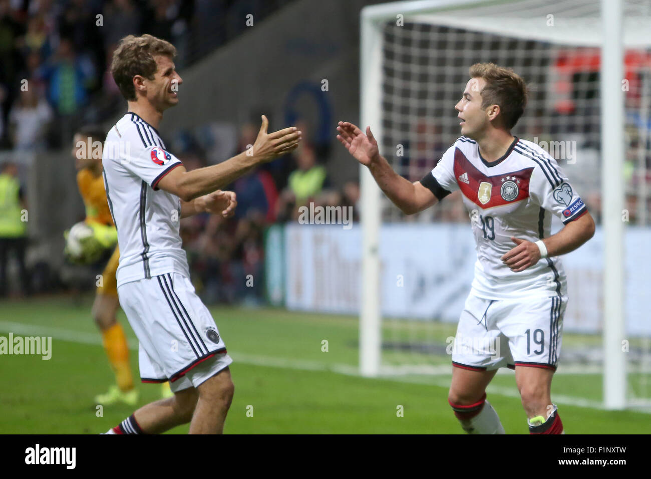 Germany goal scorers Thomas Mueller (l) and Mario Goetze celebrate Goetze's goal at 3:1 during the Group D qualifier for the European Championships at the Commerzbank-Arena in Frankfurt am Main, Germany, 4 September 2015. PHOTO: FREDRIK VON ERICHSEN/DPA Stock Photo