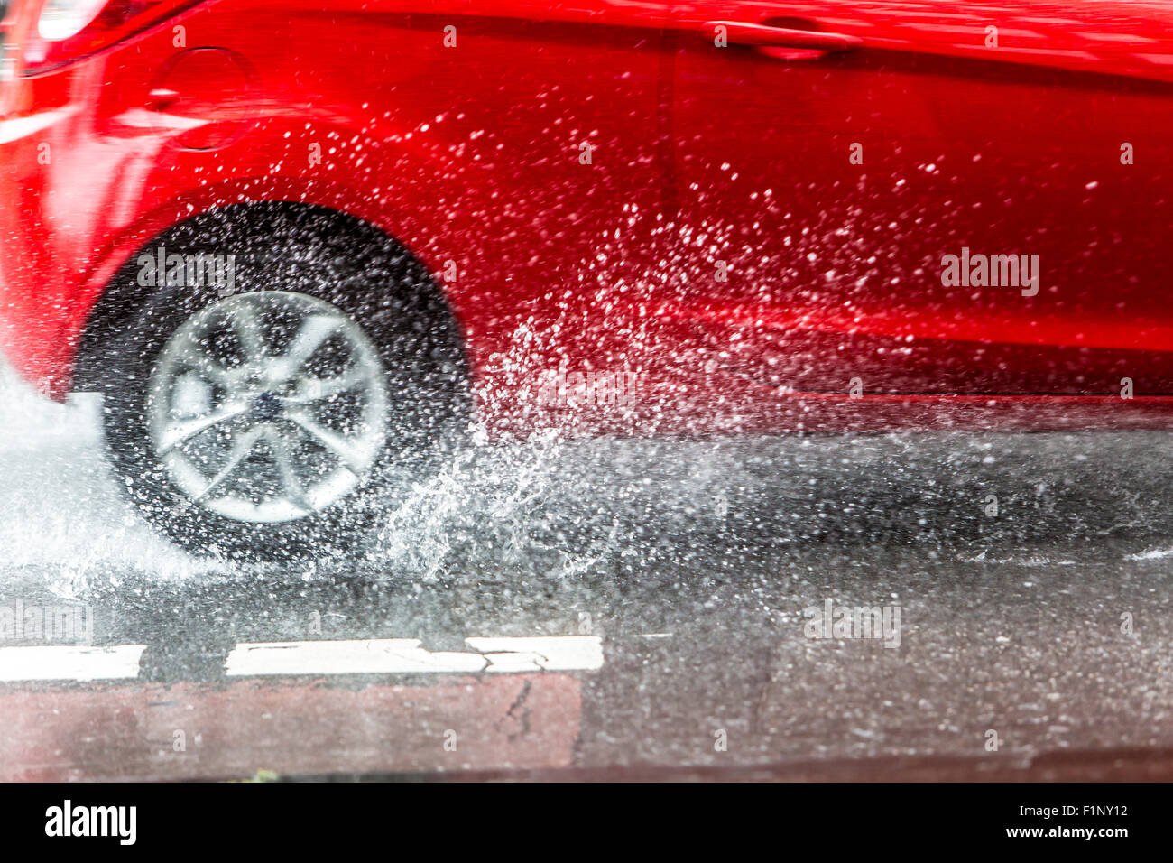 Cars driving in heavy rain weather, wet surface of the street, dangerous driving, aquaplaning