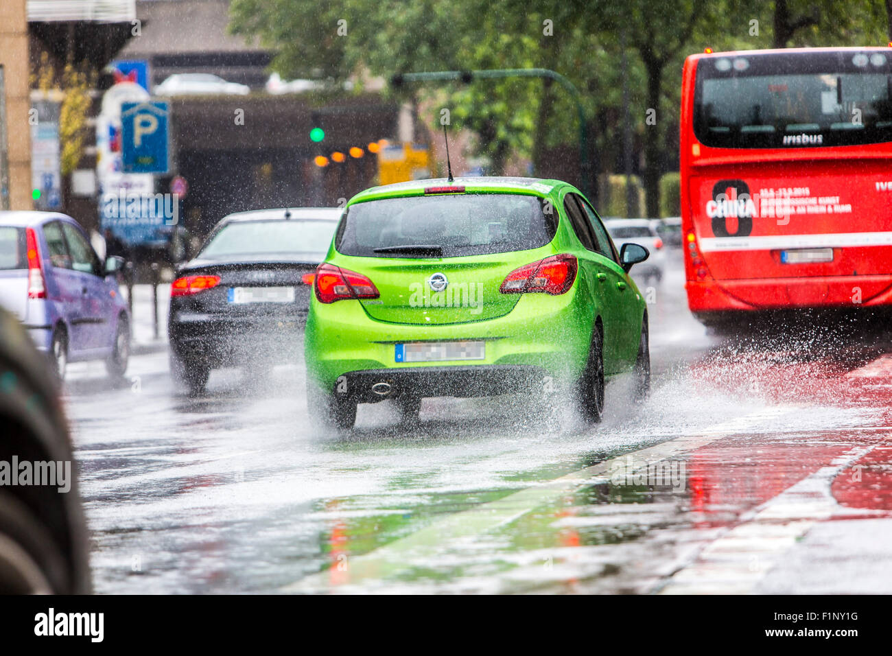 Cars driving in heavy rain weather, wet surface of the street ...