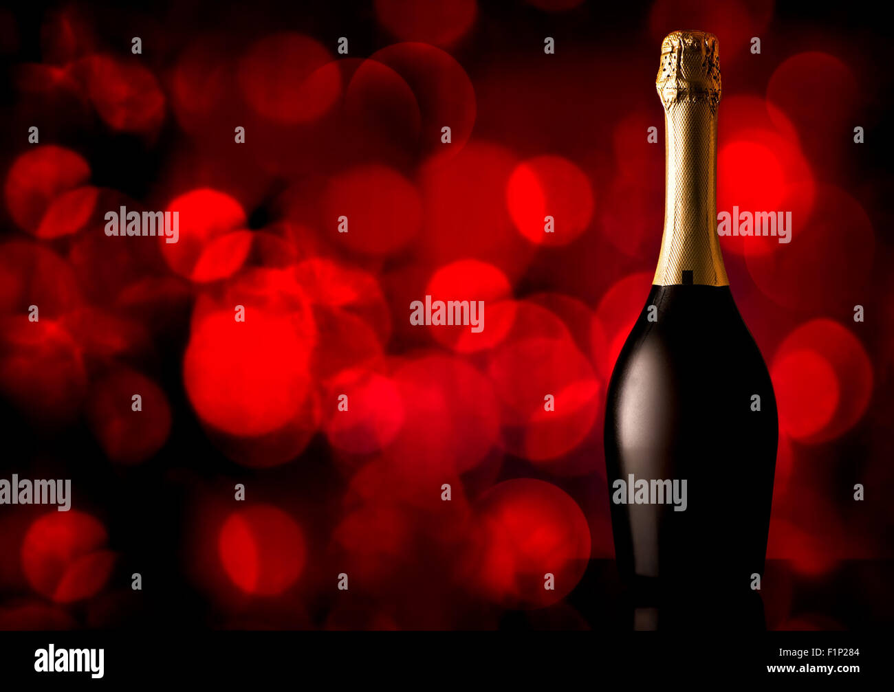 Bottle of champagne on a red background Stock Photo