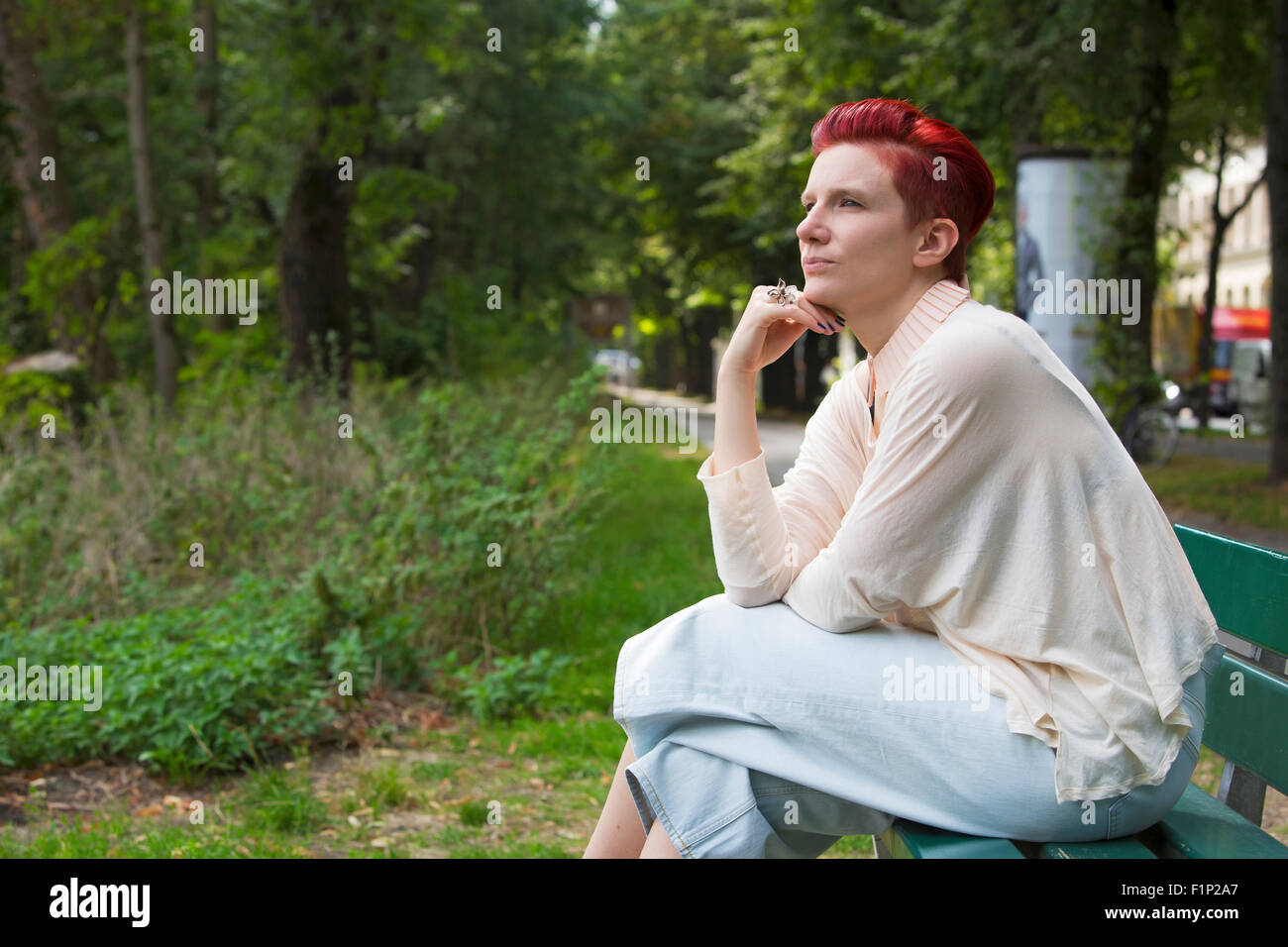 Redhead girl sitting on bench hi-res stock photography and images - Alamy