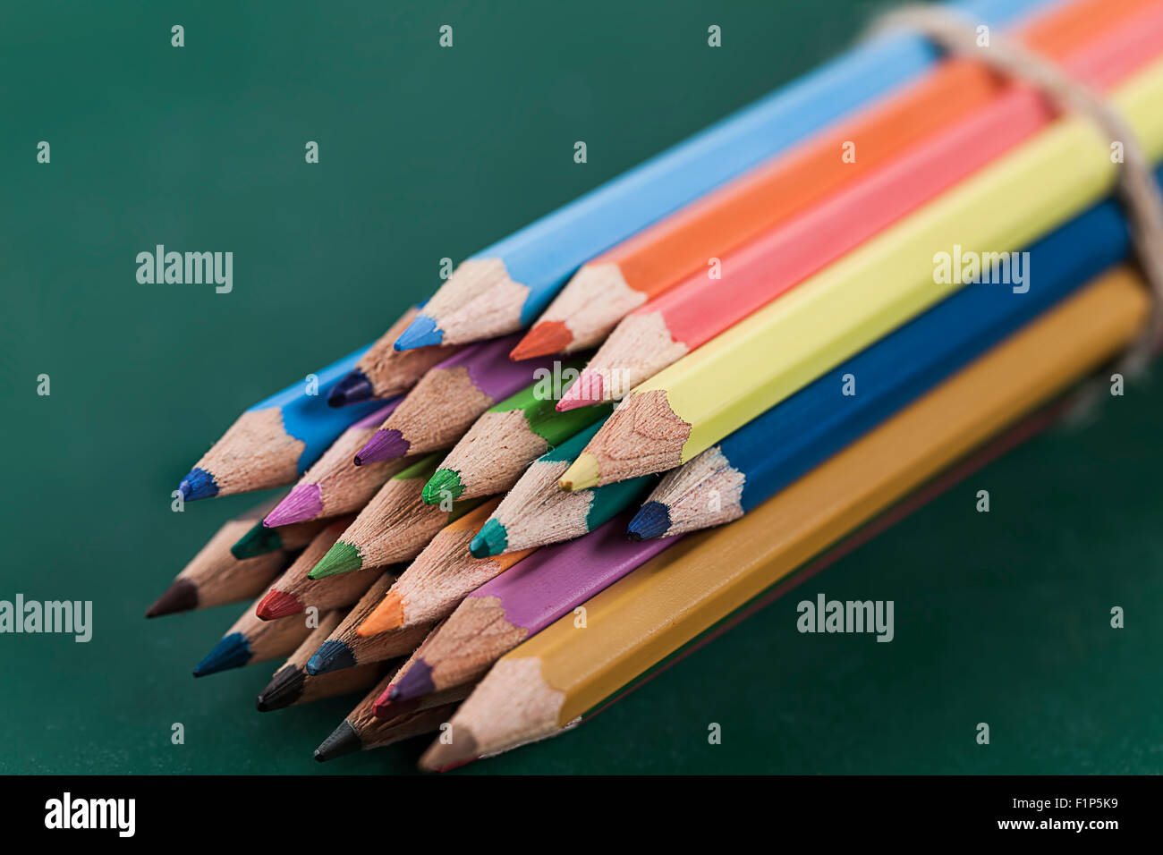 Colored pencils on green chalkboard Stock Photo Alamy
