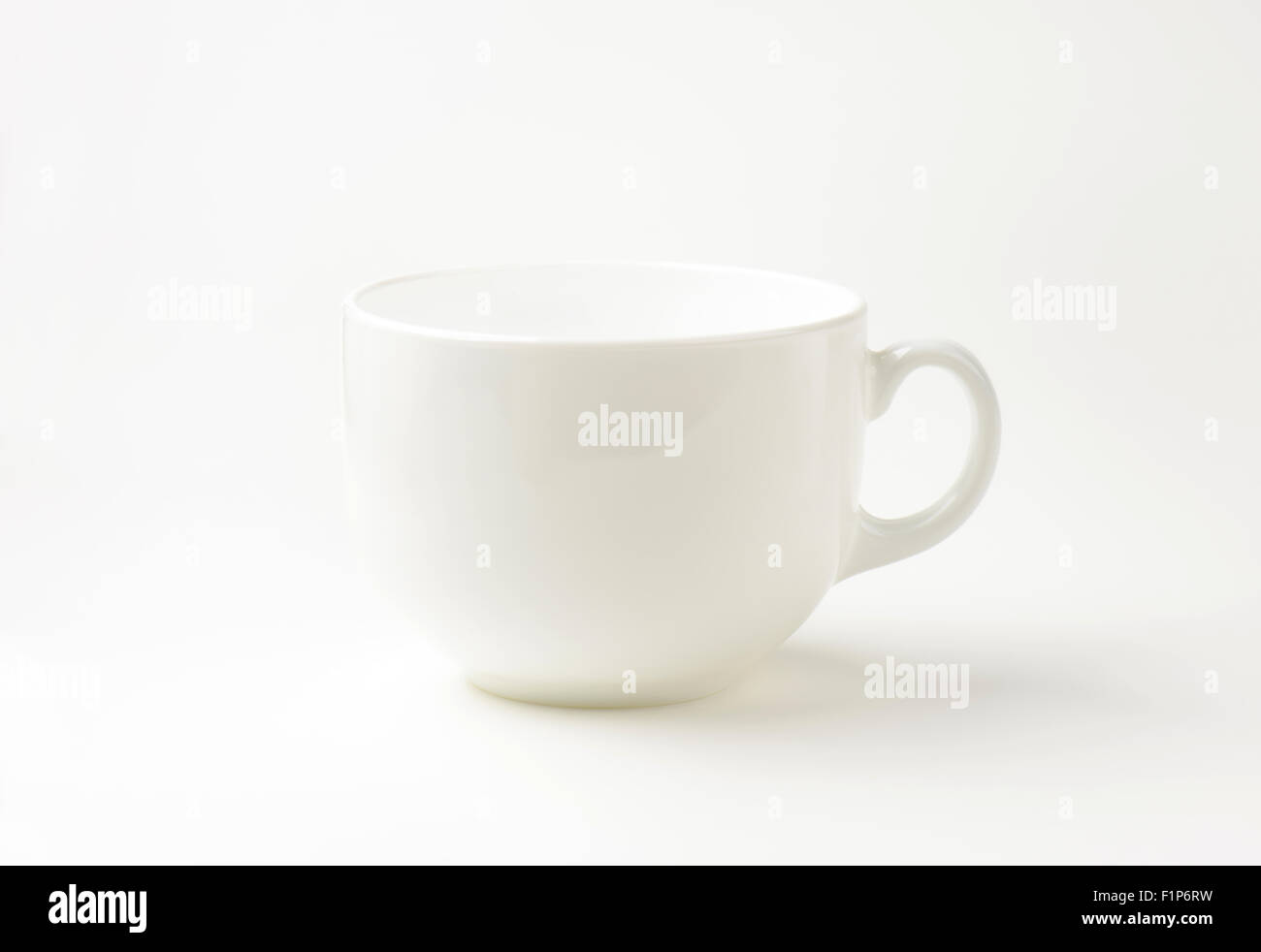 empty white mug on white background Stock Photo - Alamy