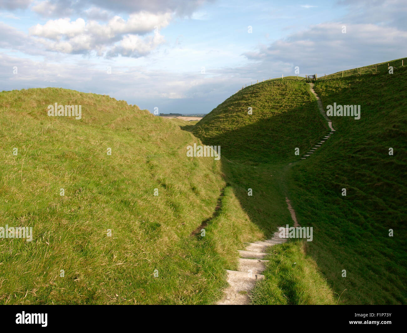 Footpath between ramparts, Maiden Castle, Iron age hill fort, Dorchester, Dorset, UK Stock Photo