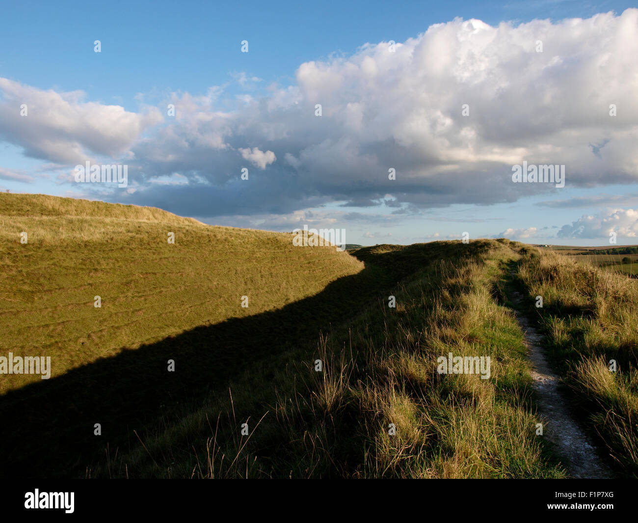 Footpath along the top of rampart, Maiden Castle, Iron age hill fort, Dorchester, Dorset, UK Stock Photo