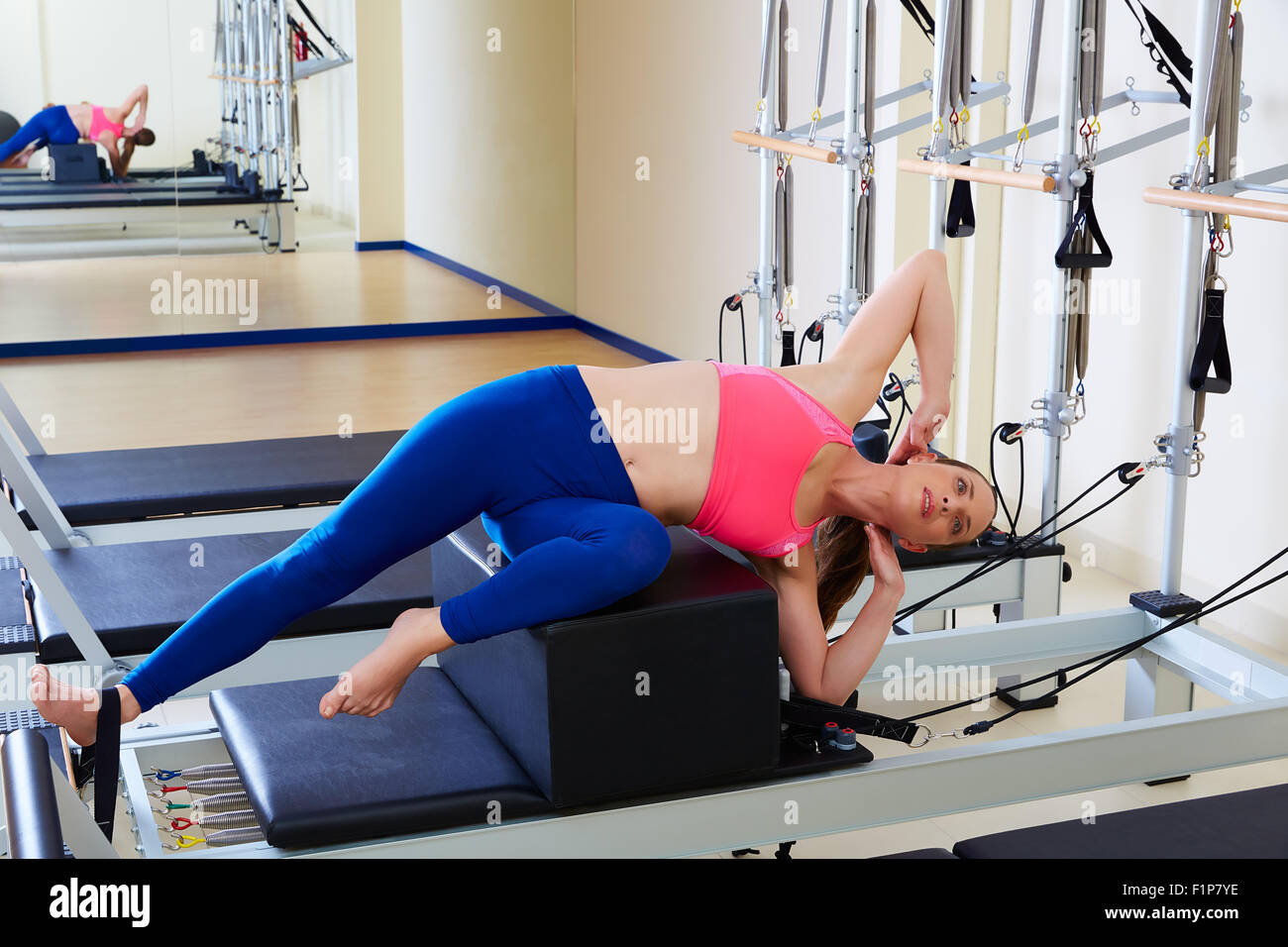 Pilates reformer woman short box side stretch exercise wrkout