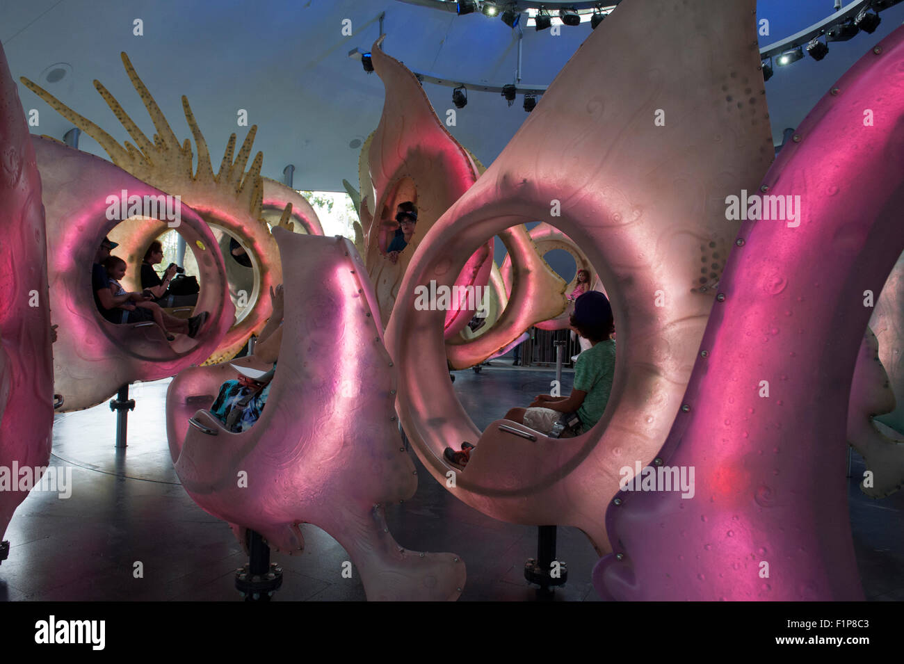 Riders on the SeaGlass Carousel in Battery Park, Manhattan, New York