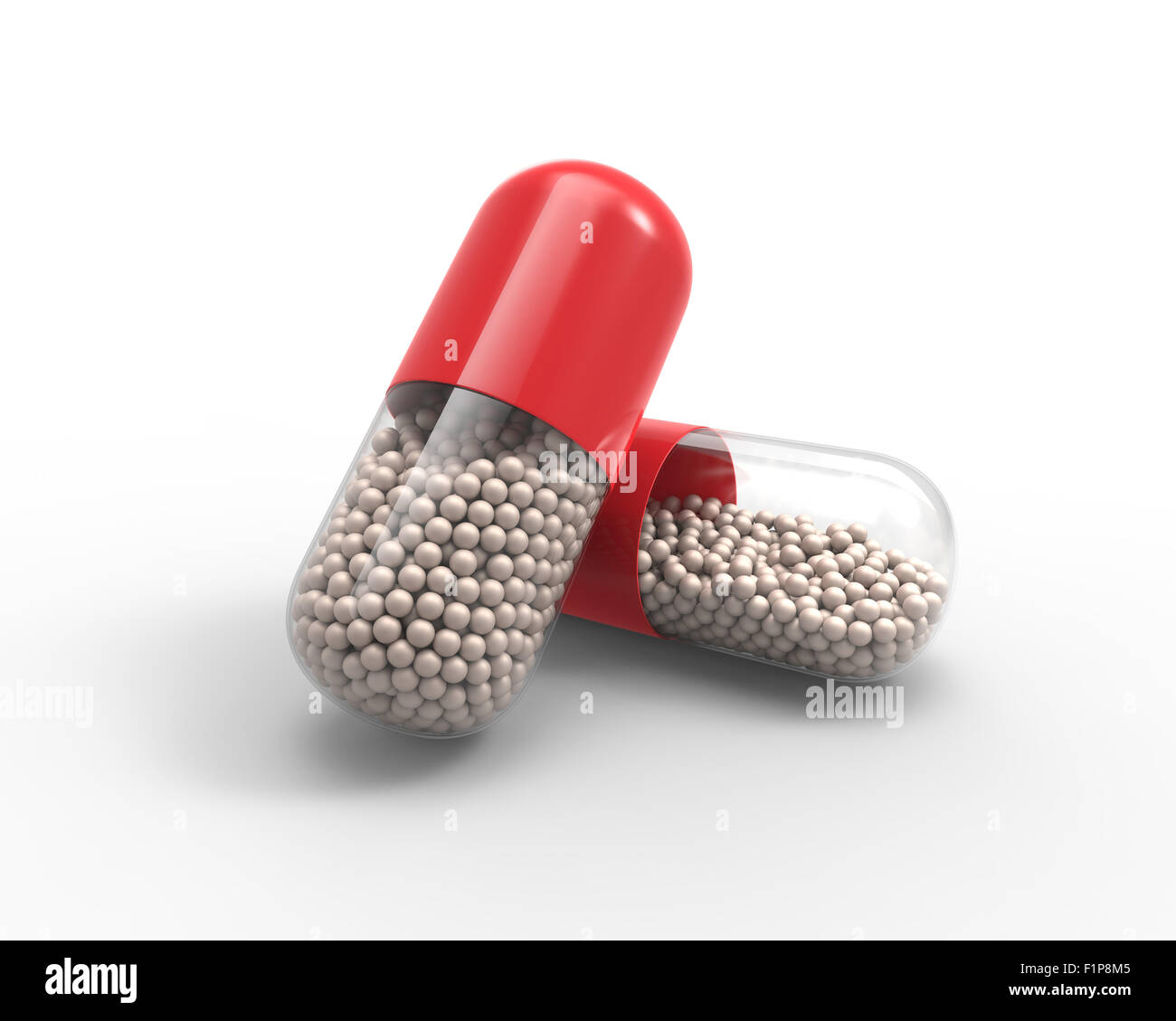 Red capsule with the granules of drugs inside 3D Stock Photo Alamy