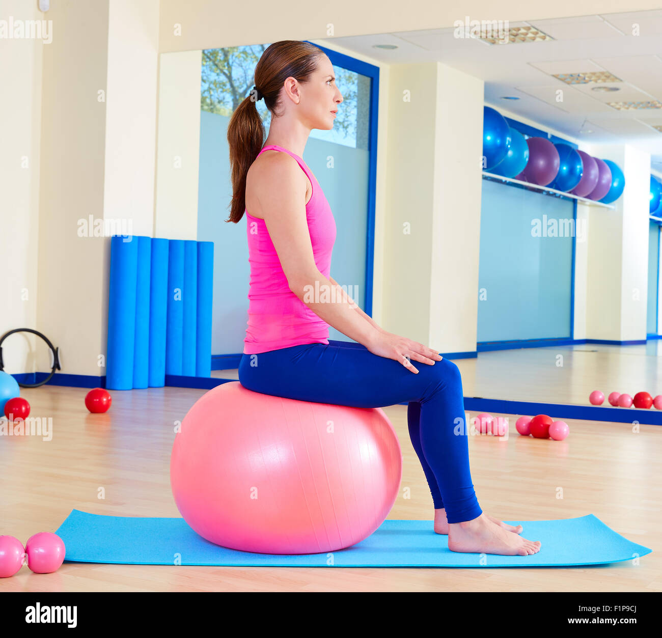 Pilates woman fitball swiss ball exercise workout at gym indoor Stock ...