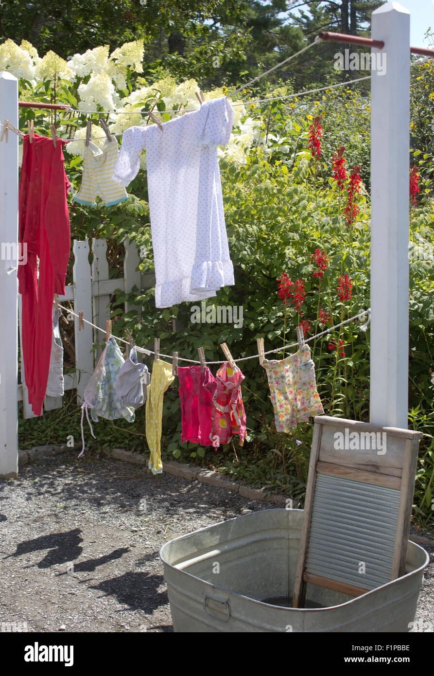 Children's clothing drying on a clothesline. Stock Photo
