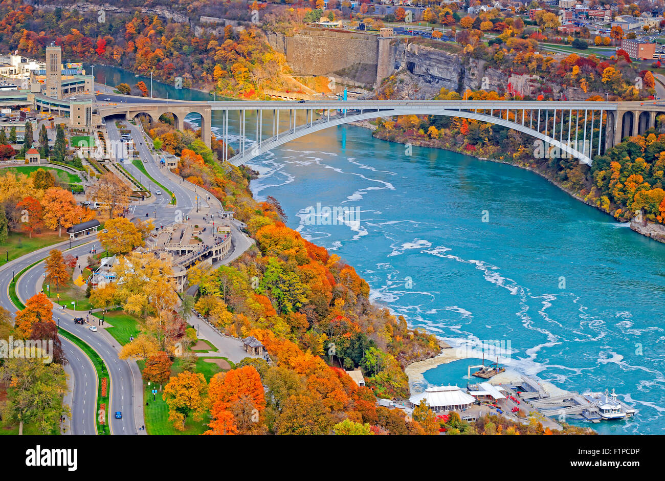 Rainbow Bridge Over Niagara River with fall colors in Canada and American side of the gorge. Stock Photo