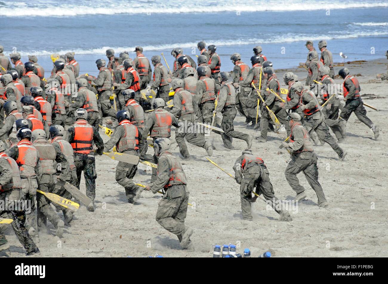 US Navy SEAL candidates cover themselves in sand during surf passage on Naval Amphibious Base Coronado September 2, 2015 in San Deigo, California. Stock Photo