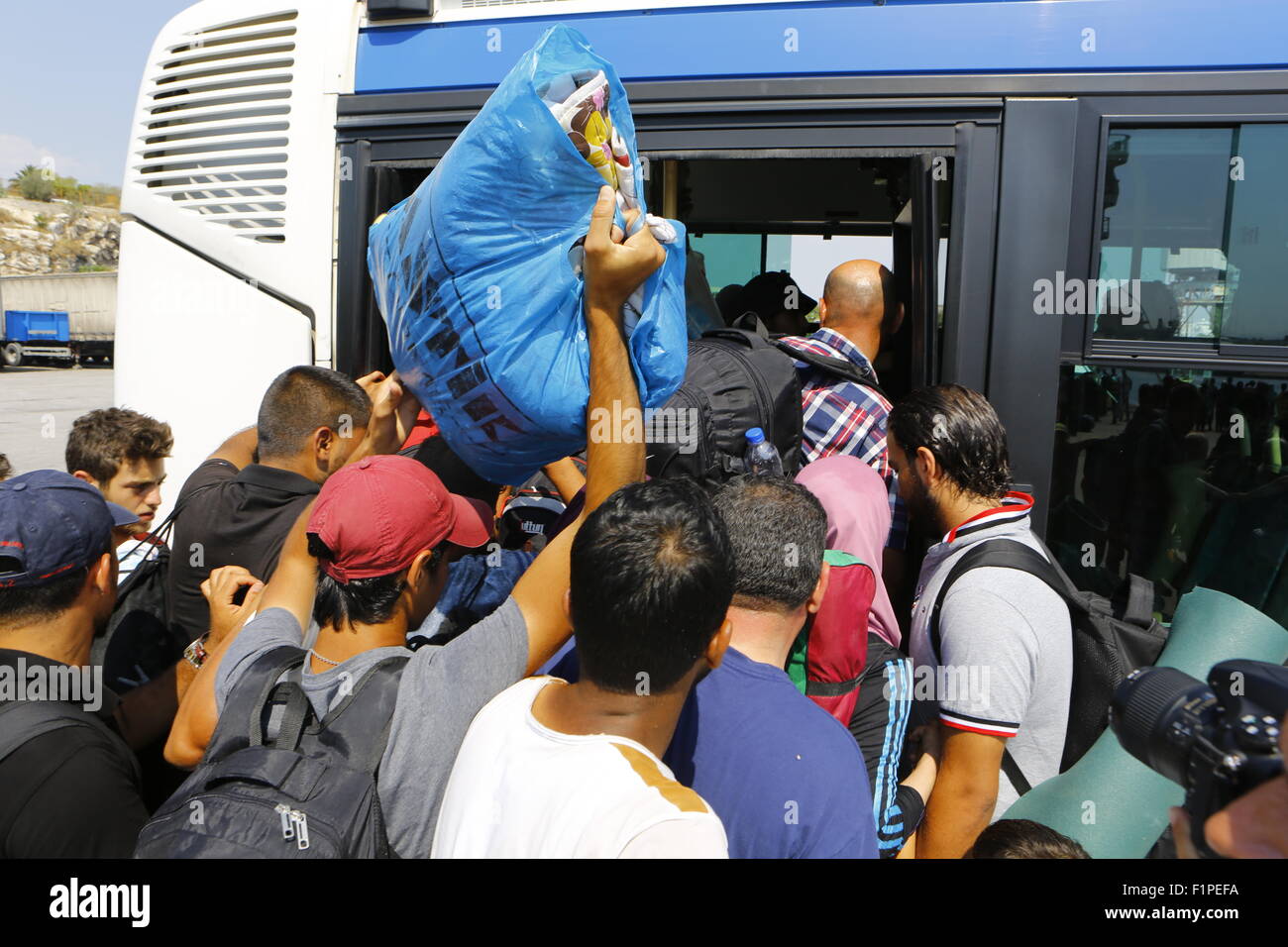 Greece. 05th Sep, 2015. Migrants trying to get onto the already overcrowded bus that will bring them to Piraeus train station for further transport into Athens. Thousands of migrants from Syria, Iraq and Afghanistan come to Athens on a near daily basis from the Greek islands which they reached from Turkey. For many of these refugees, Athens is just a stopover on their journey to northern European countries. Credit:  Michael Debets/Pacific Press/Alamy Live News Stock Photo