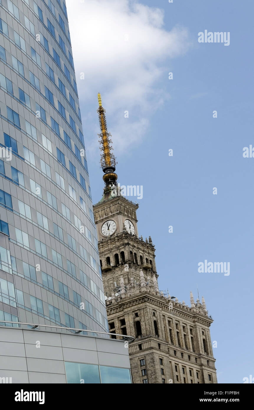 Palace of Culture - Palac Kultury close-up, while renovated clock tower, old and new architecture side by side,  Warszawa, Warsa Stock Photo