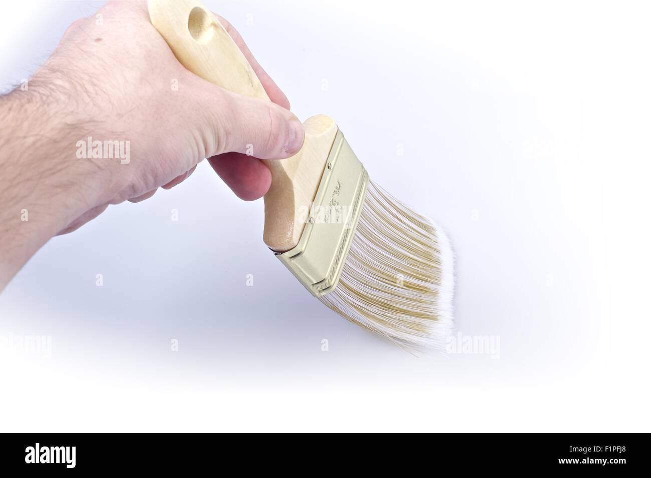 Painting Time. Male Hand and Brush Stock Photo