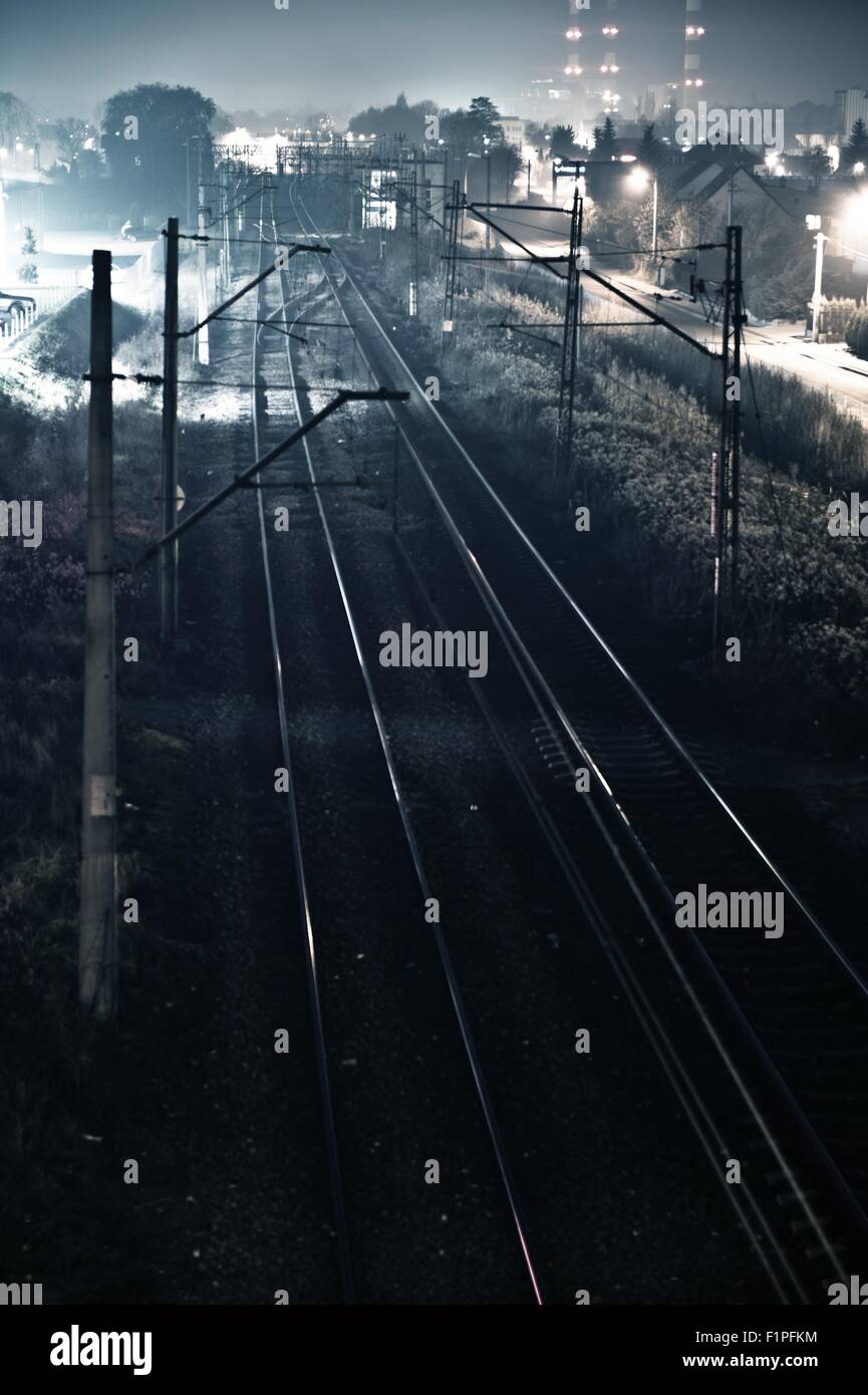 Railroad Tracks Somewhere in Poland, Europe. Railroads in Night Time Photography. Vertical Railroads Photo. Stock Photo