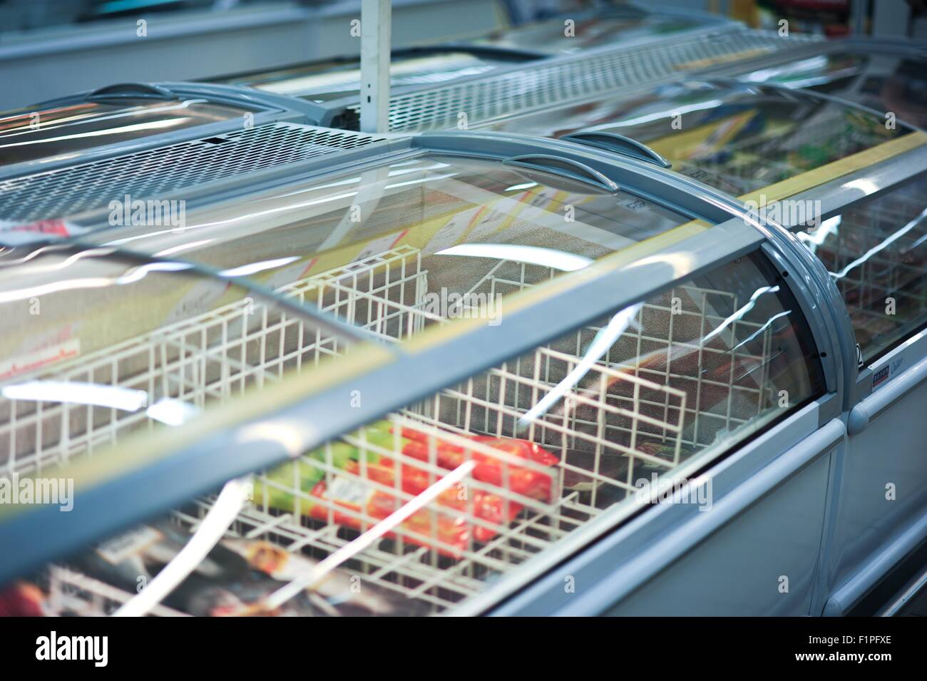 Commercial Refrigerator with Ice-Creams Inside. Cooling Storage - Refrigerator Horizontal Photo. Stock Photo