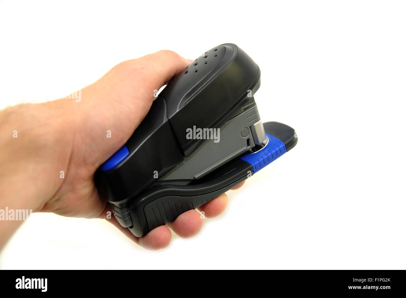 Black Plastic Office Stapler in Hand. White Separated Background. Stock Photo