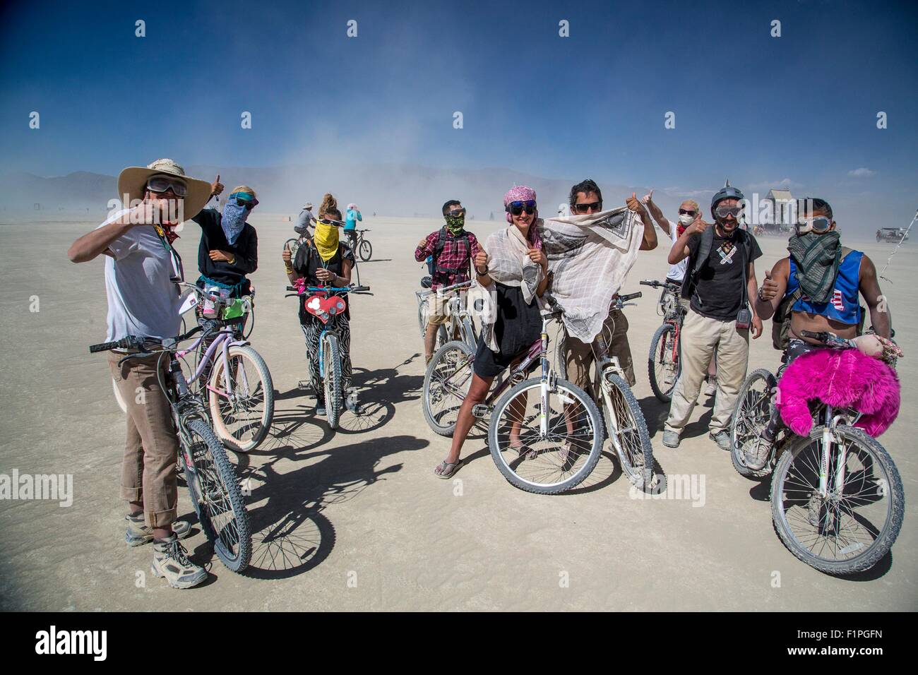 Burners on their bikes following a sand storm in the desert during the annual Burning Man festival September 5, 2015 in Black Rock City, Nevada. Burning Man's official art theme this year is 'Carnival of Mirrors' and is expected to be attended by 70,000 people for the week long event. Stock Photo