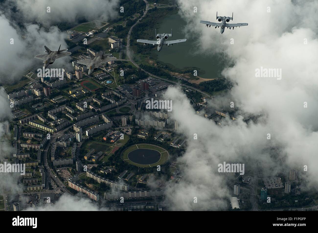 U.S. Air Force F-22 Raptor stealth fighter aircraft and A-10 Thunderbolt ground attack aircraft fly over the capital in formation during a forward deployment in support of NATO partners in Europe September 4, 2015 over Tallinn, Estonia. Stock Photo