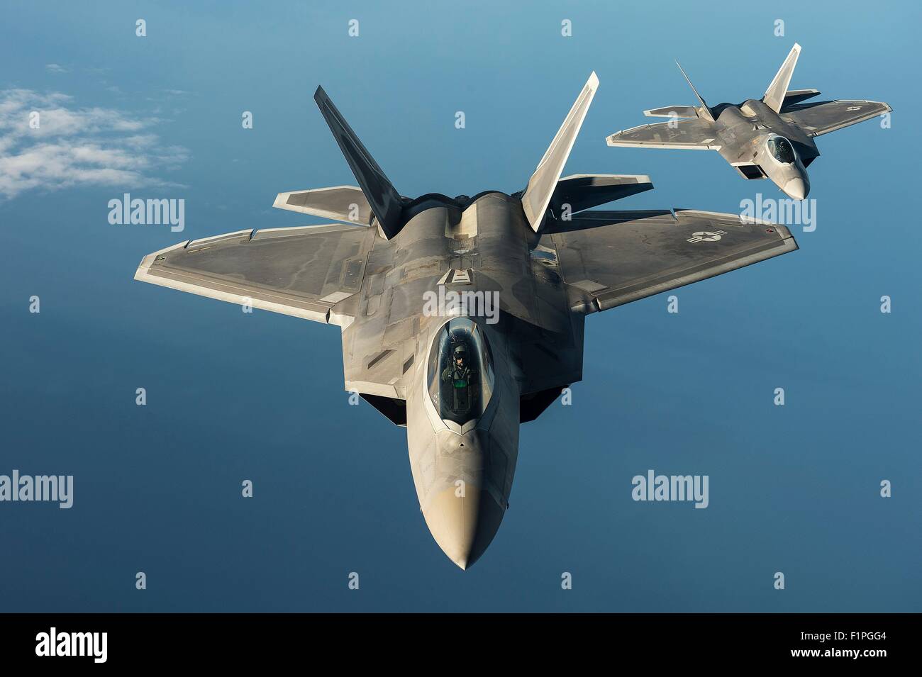 U.S. Air Force F-22 Raptor stealth fighter aircraft fly in formation over the Baltic Sea during a forward deployment in support of NATO partners in Europe September 4, 2015 near Tallinn, Estonia. Stock Photo