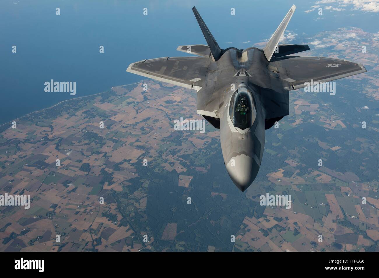 A U.S. Air Force F-22 Raptor stealth fighter aircraft flies in formation over the capital during a forward deployment in support of NATO partners in Europe September 4, 2015 over Tallinn, Estonia. Stock Photo