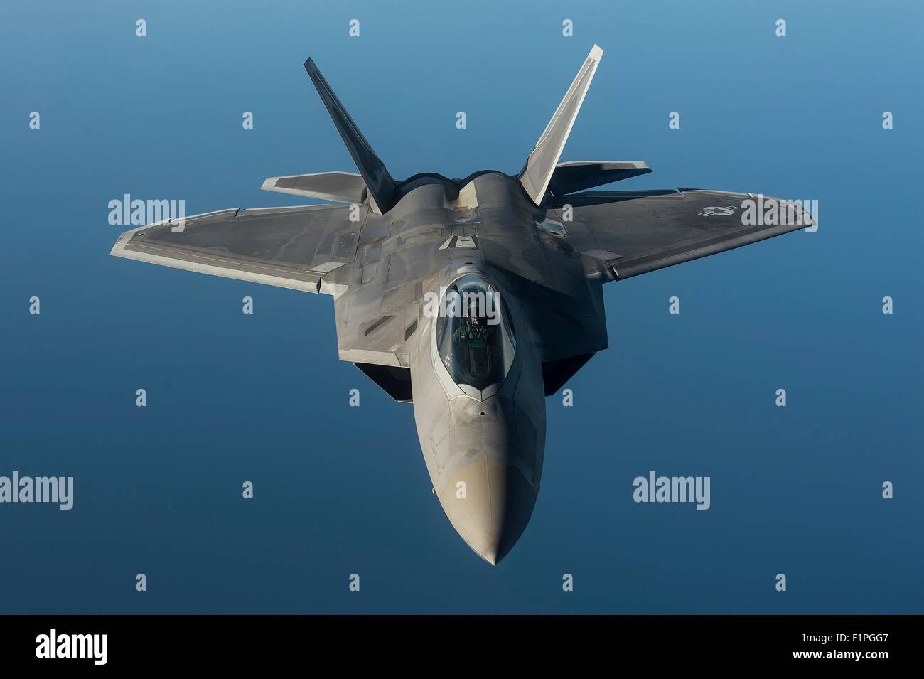 A U.S. Air Force F-22 Raptor stealth fighter aircraft flies in formation over the Baltic Sea during a forward deployment in support of NATO partners in Europe September 4, 2015 near Tallinn, Estonia. Stock Photo