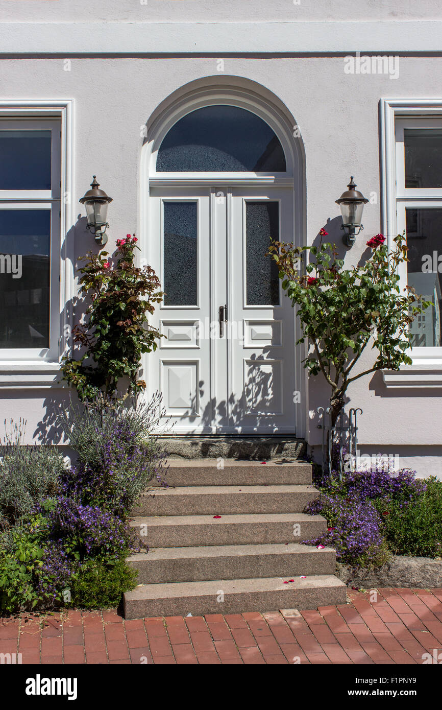 Entrance door with summer flowers Stock Photo - Alamy