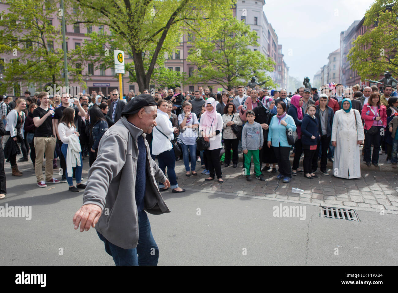 Turkish man dancing in front of people celebrating may day at the first of May in Kreuzberg Berlin Stock Photo