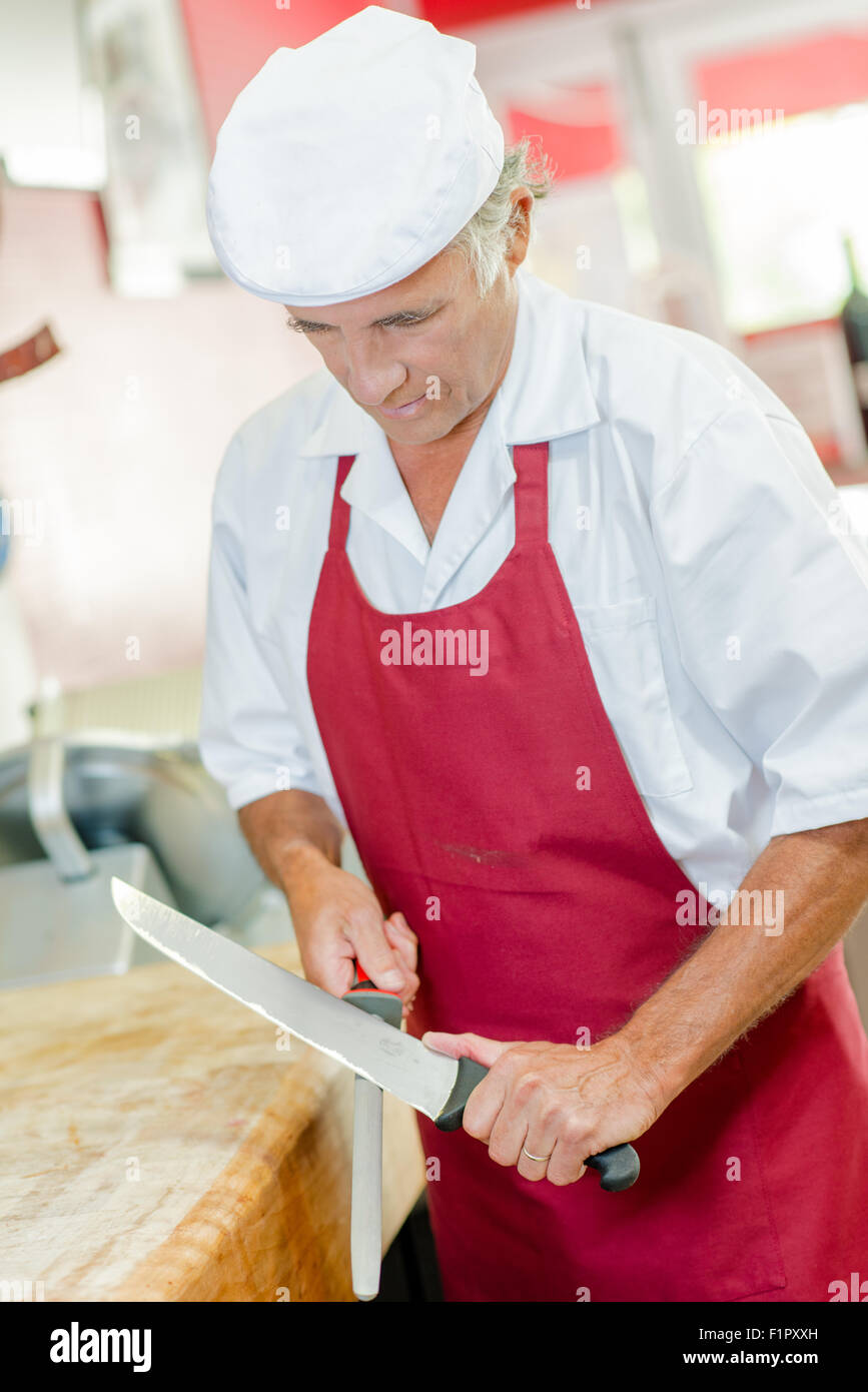 Butcher sharpening knife Stock Photo Alamy