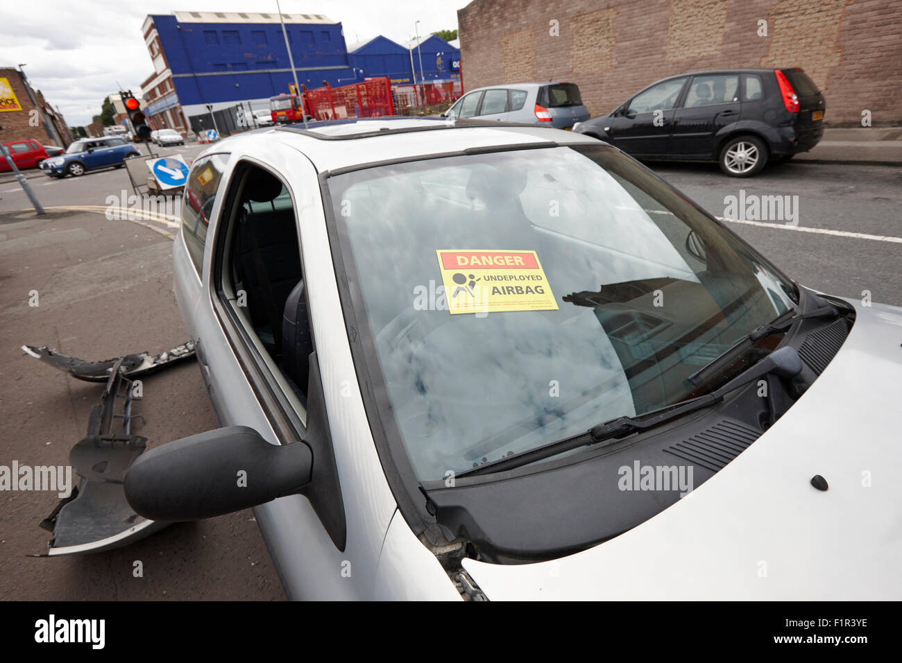 danger undeployed airbag warning sticker on the windscreen of a car involved in an accident Birmingham UK Stock Photo