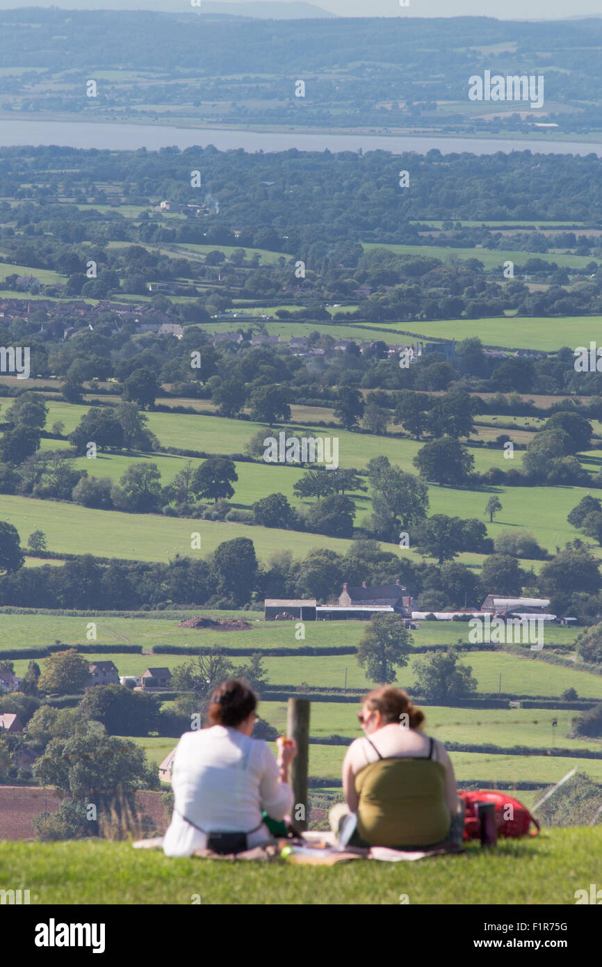 Gloucestershire, UK. 6th September, 2015. Visitors bask in the unseasonably warm September weather at a popular picnic site, Coaley Peak  overlooking the Severn Vale and river Severn in Gloucestershire. Credit:  Wayne Farrell/Alamy Live News Stock Photo