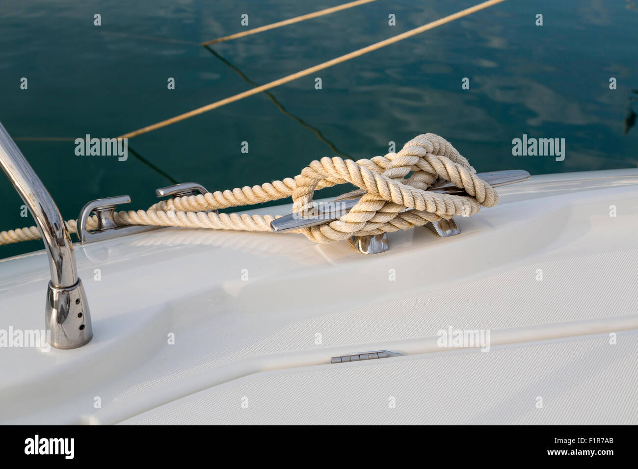 Close-up nautical knot rope tied around stake on boat or ship, boat mooring rope. Stock Photo