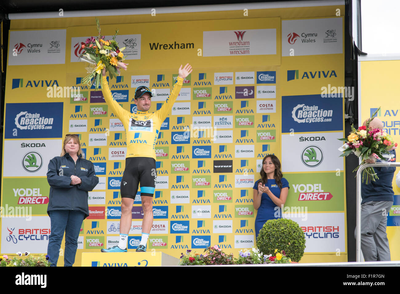 London, UK. 6th September, 2015. Race leader Elia Viviani wears the yellow jersey on the podium following stage one of the Aviva Tour of Britain between Beaumaris and Wrexham, United Kingdom on 6 September 2015. The race starts on 6 September in Beaumaris, Anglesey, and ends on 13 August in London, United Kingdom. Credit:  Andrew Peat/Alamy Live News Stock Photo
