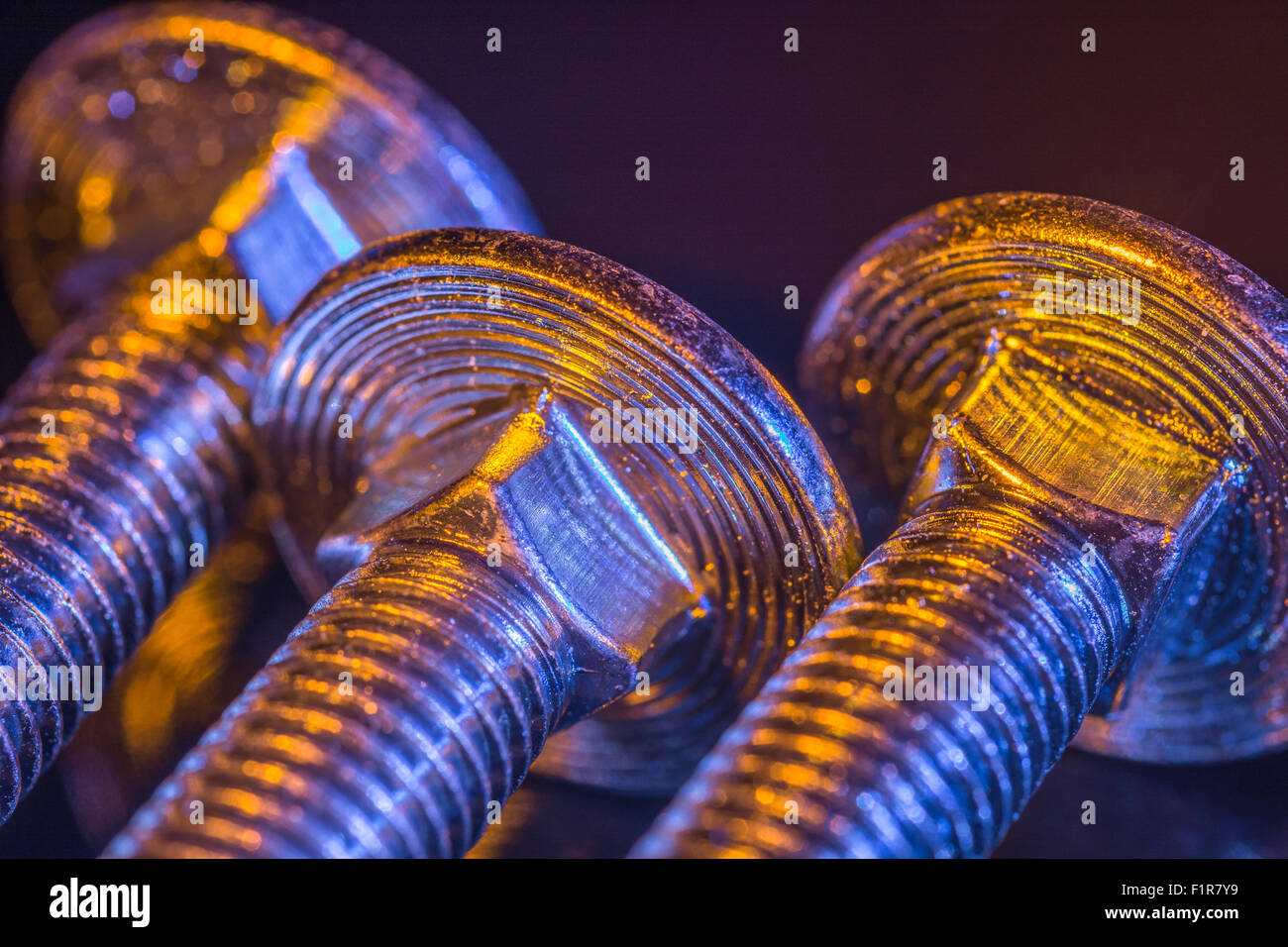 Set of bolt heads taken under artificial lighting. Macrophoto Stock