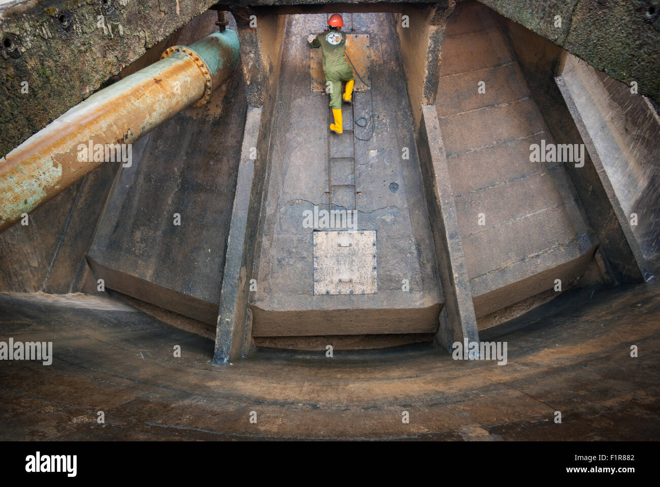 Jakarta, Indonesia. 18th June 2021. A worker is conducting maintenance cleaning on source water processing installation in Jakarta, Indonesia. Stock Photo