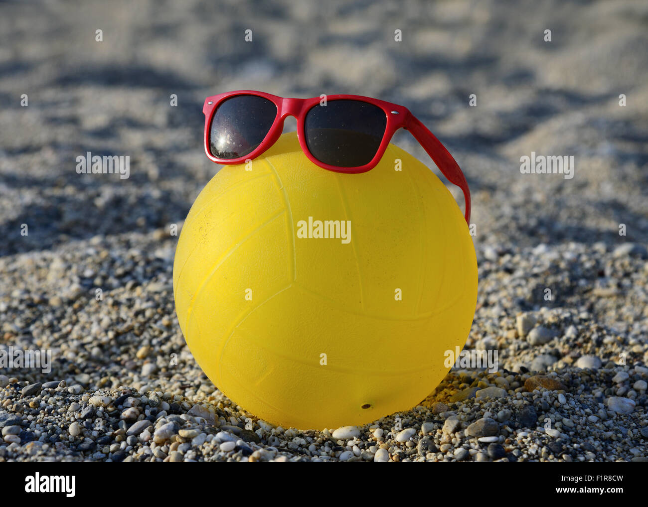 ball in sunglasses on summer beach Stock Photo