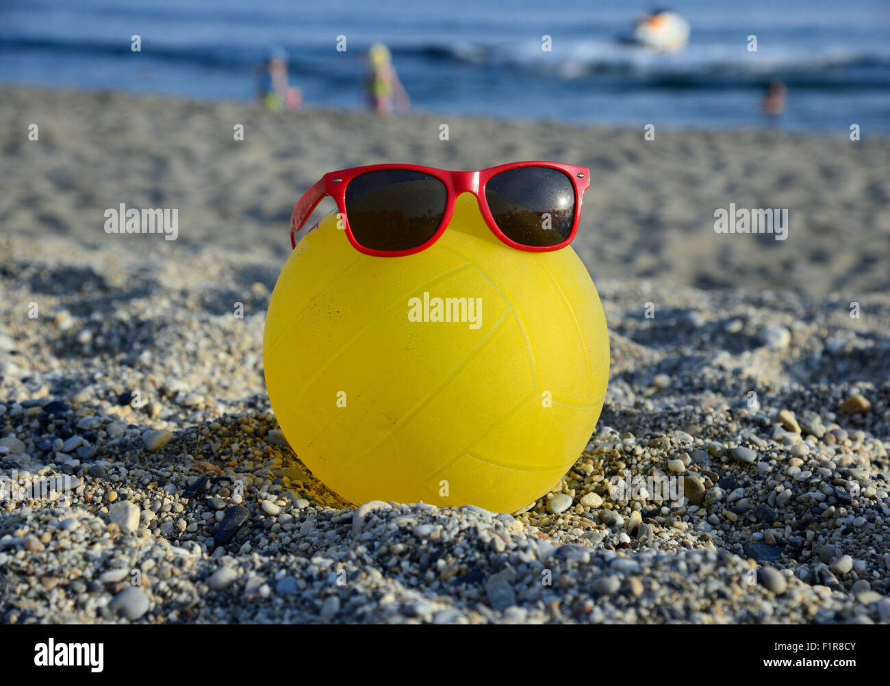 ball in sunglasses on summer beach Stock Photo