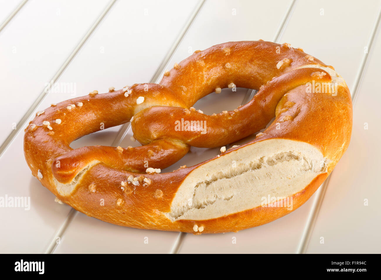 A pretzel is a type of baked bread product made from dough most