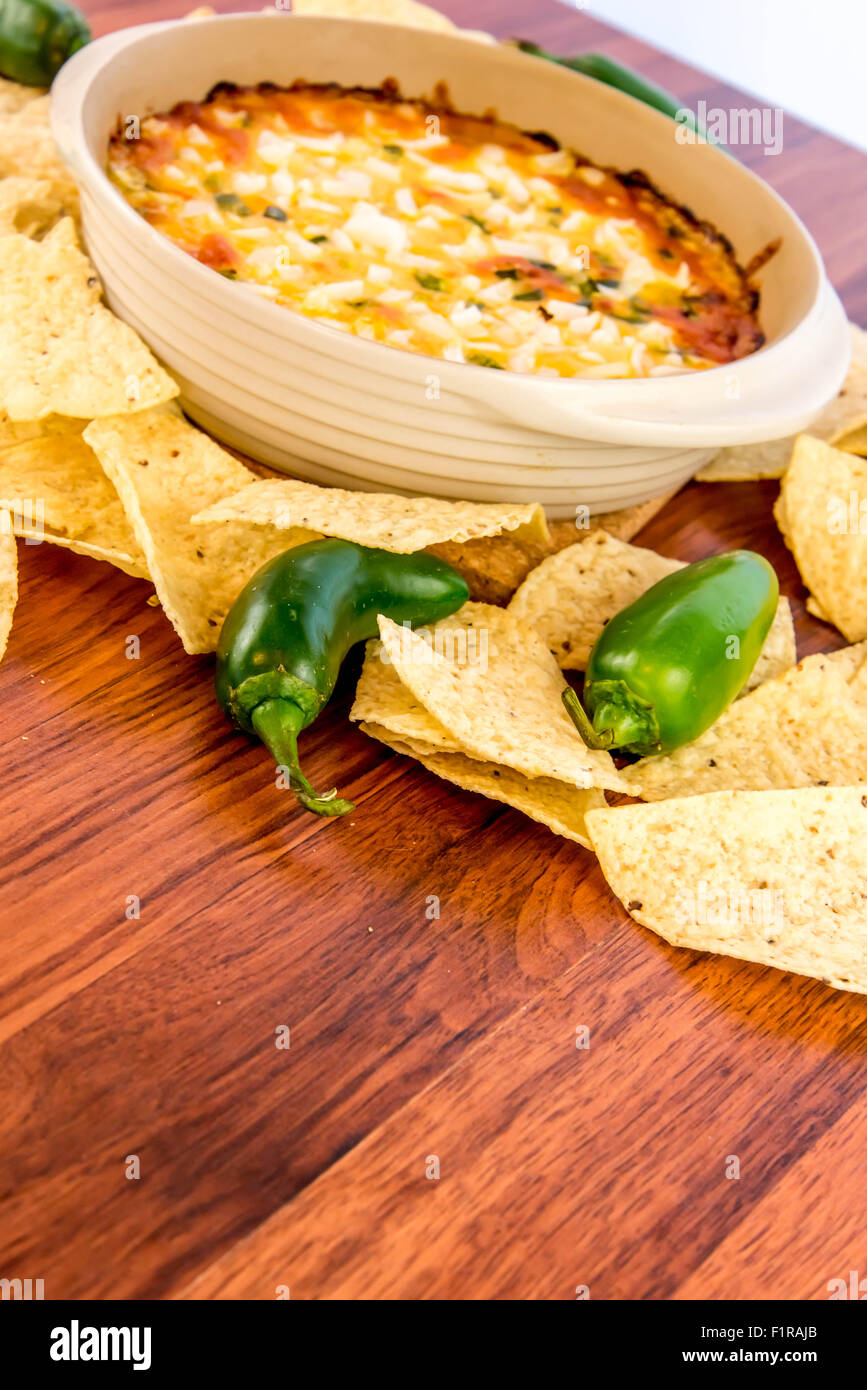 hot layered bean dip with jalapenos, sour cream and melted cheddar