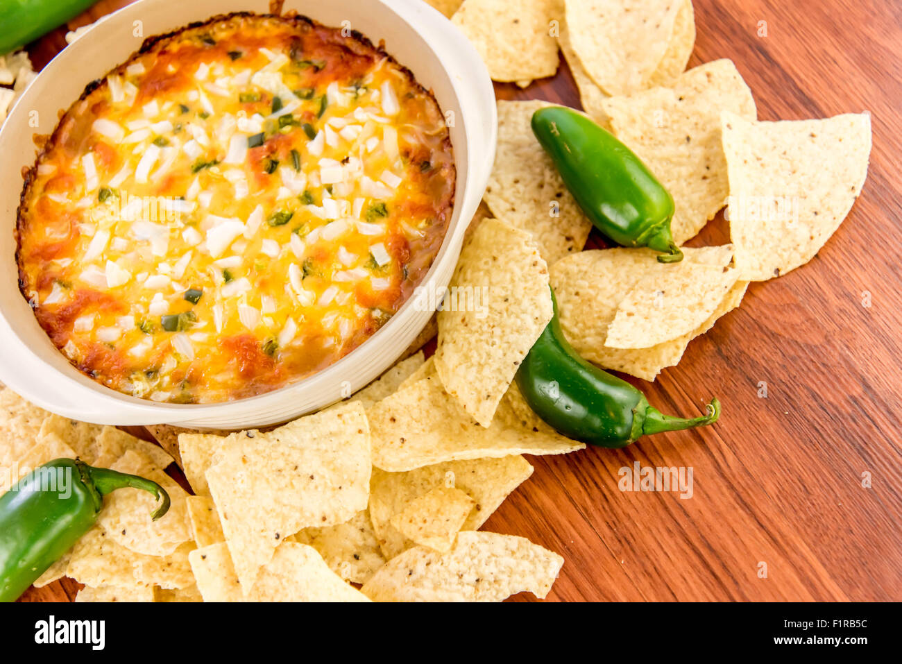 hot layered bean dip with jalapenos, sour cream and melted cheddar