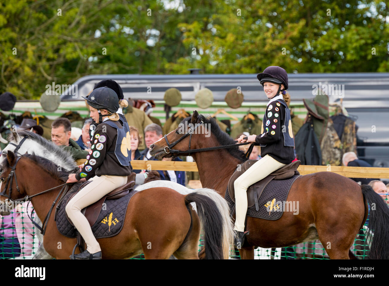 Young girls riding their ponies in a competition at The Beckbury Show 2015 Shropshire UK Stock Photo