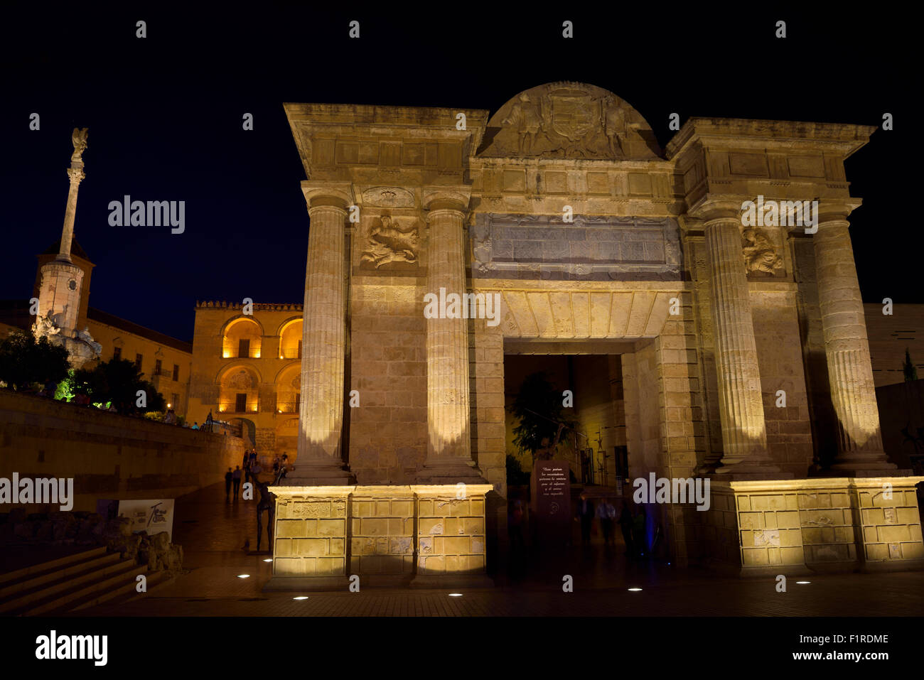 Puerta del Puente Roman Bridge Gate at night with Saint Raphael triumphal statue and Cordoba Cathedral Stock Photo