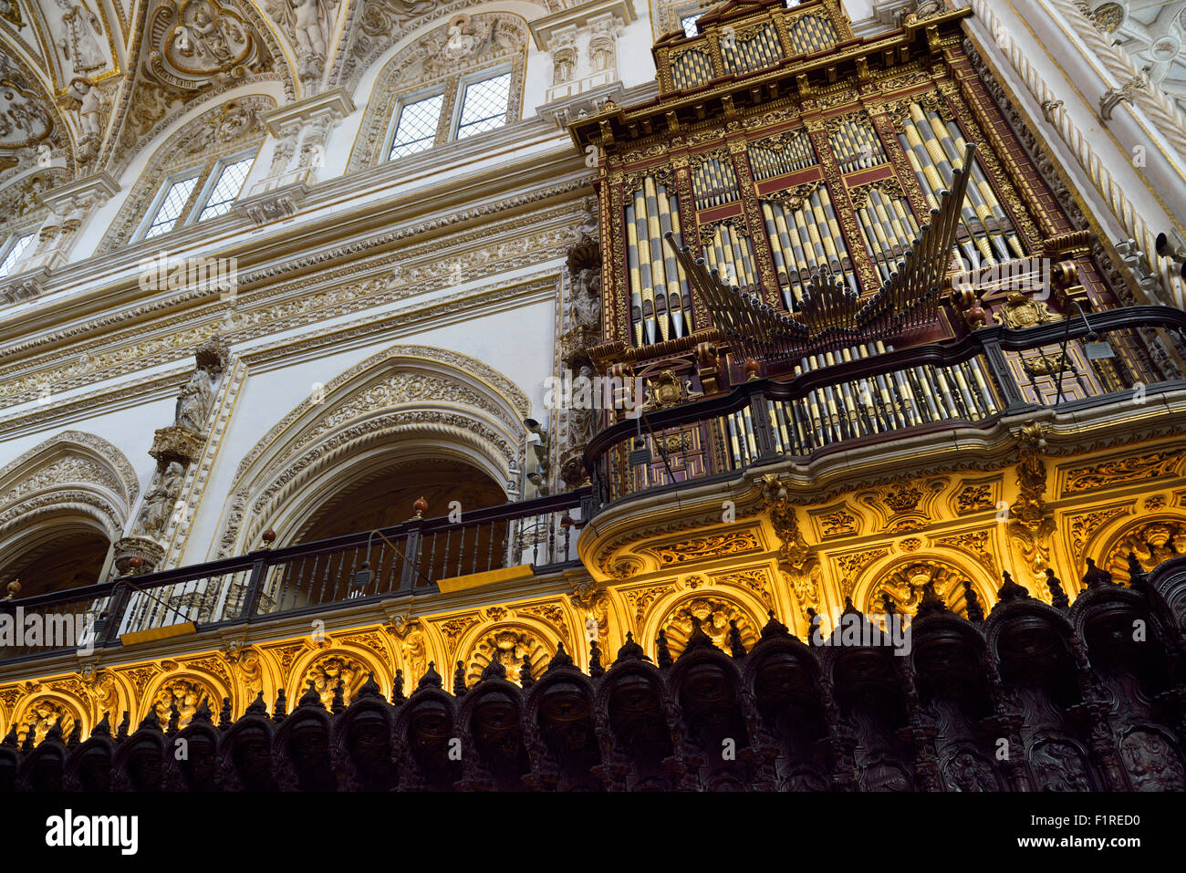 Pipe organ and baroque carved mahogany seats in the choir of Cordoba Cathedral Mosque Stock Photo